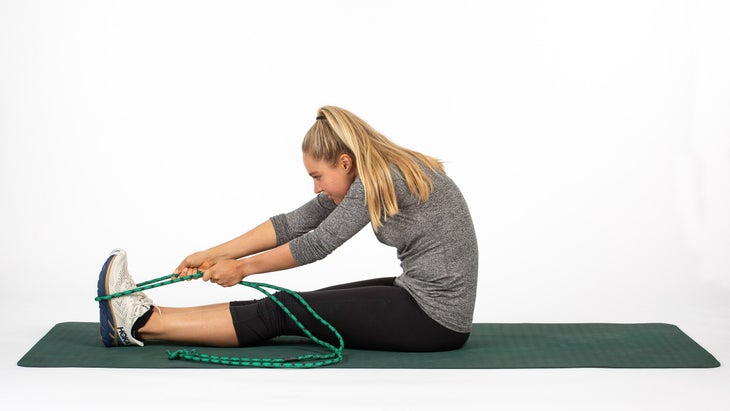 Woman stretching upper calf and hamstring