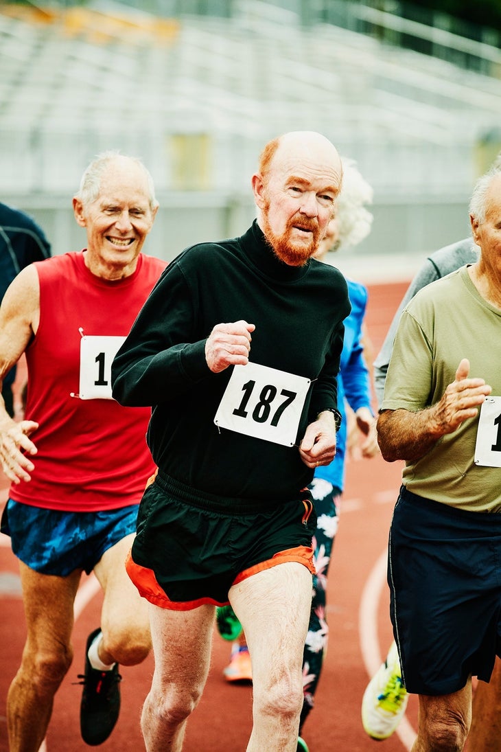 Senior track athletes running a mile race on track