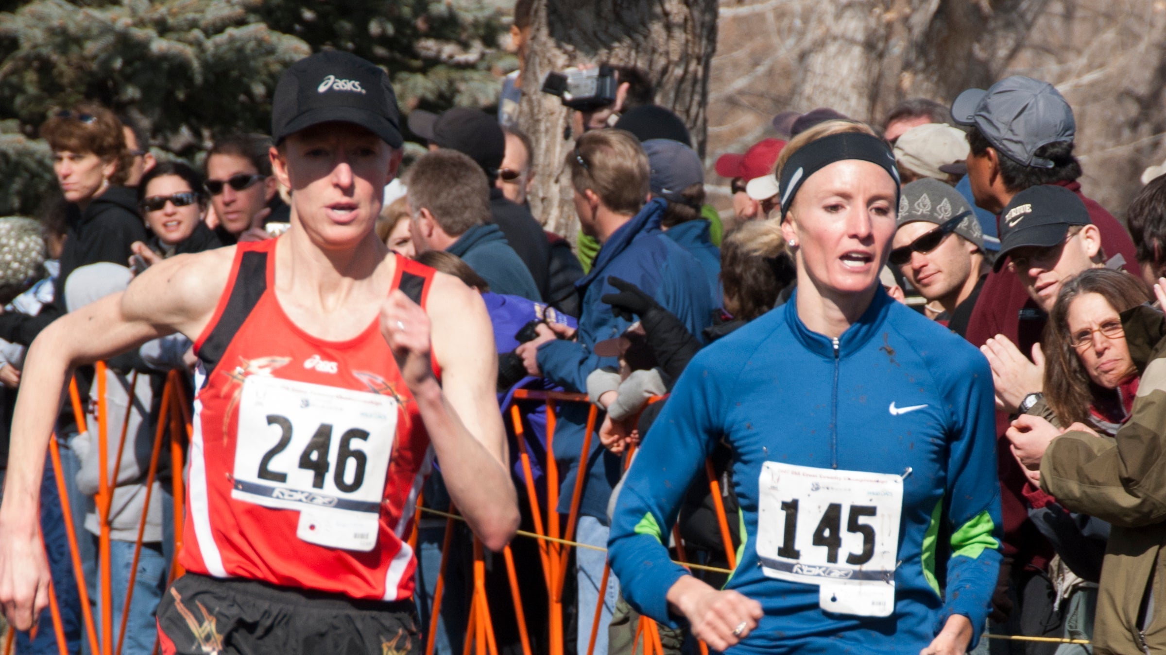 Deena Kastor and Shalane Flanagan running past spectators