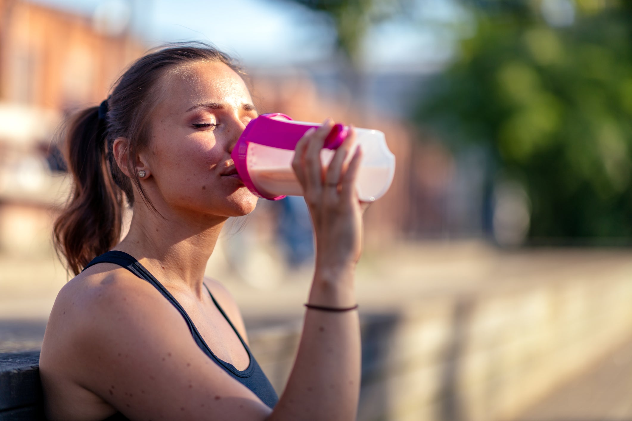 An athlete drinks a recovery shake for runners