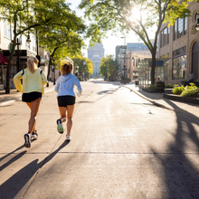 two women run on state street in Madison, WI