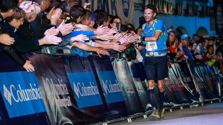 Ludo Pommeret high-fiving spectators at the finish line.