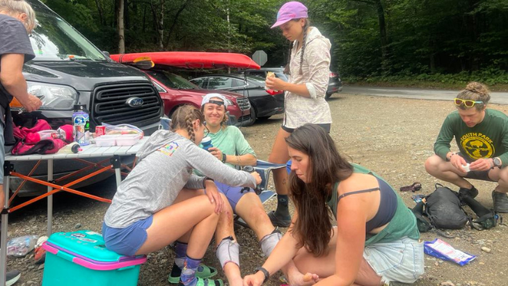 Tara Dower receives foot management from her crew. Her goal during the record attempt was to raise $20,000 for the nonprofit Girls on the Run. A week after she broke the record, donations had reached over $39,00. 