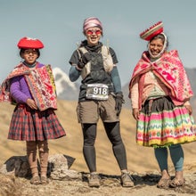 Andes Race ultramarathon runner posing with two locals