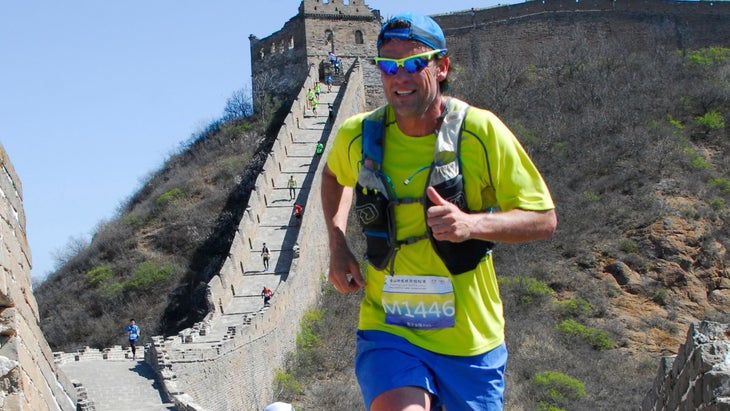 Vacation race where Brian is running along the Great Wall of China with a race bib on.