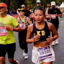 how to get into the new york city marathon. a group of runners about to finish the NYCM in 2025.