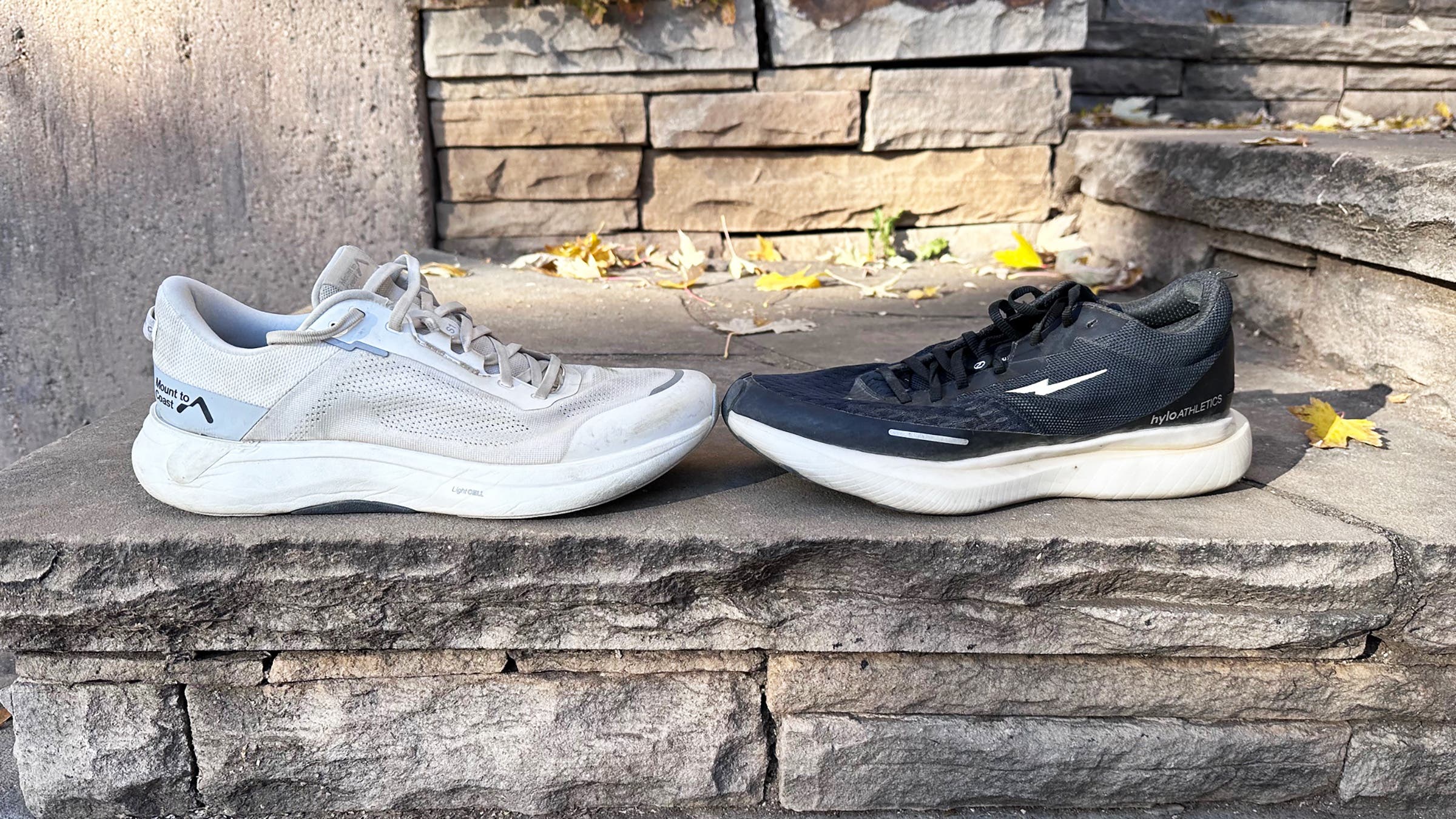 Men's running shoes displayed on stone steps, showcasing wear and dirt for cleaning men's running shoes tips.