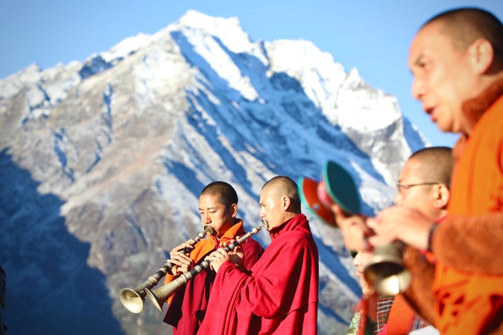 Buddhist monks chanting and praying for the land and safe passage of the runners at the start of the Snowman Race in Laya, Bhutan.