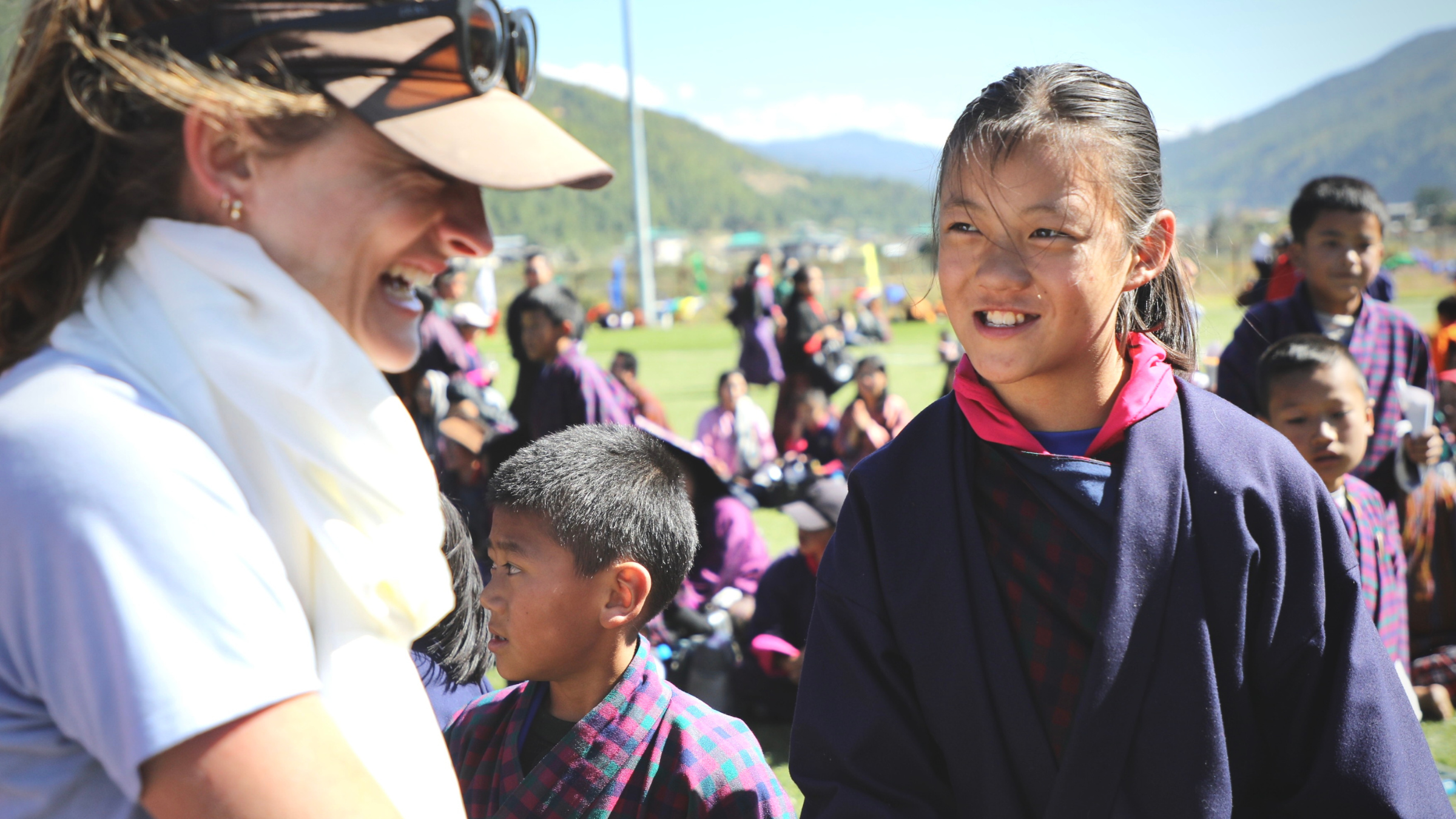 The author high-fiving schoolchildren at the finish of the Snowman Race in Jakar, Bhutan. The town celebrated the race’s finish as a holiday. 