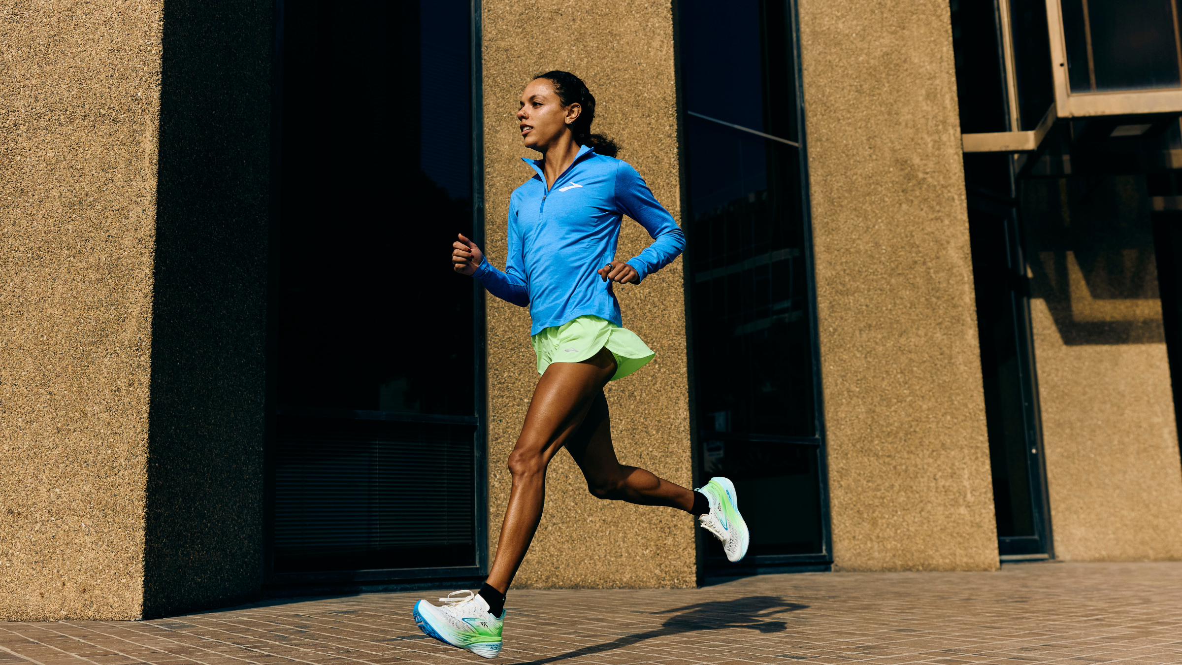 Brooks-sponsored professional runner Erika Kemp running in a city