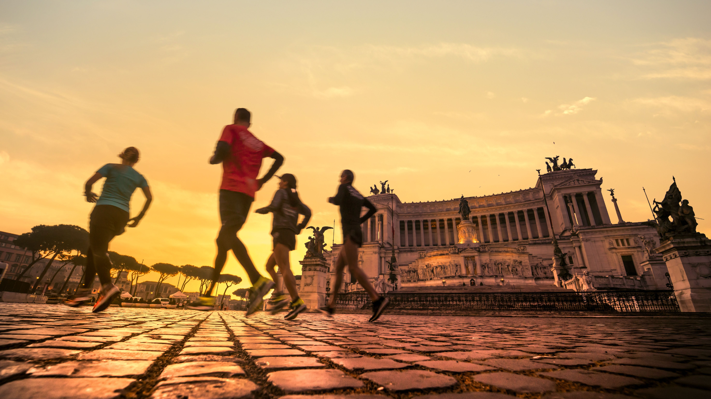 Runners enjoy the empty sights of Rome at sunrise.