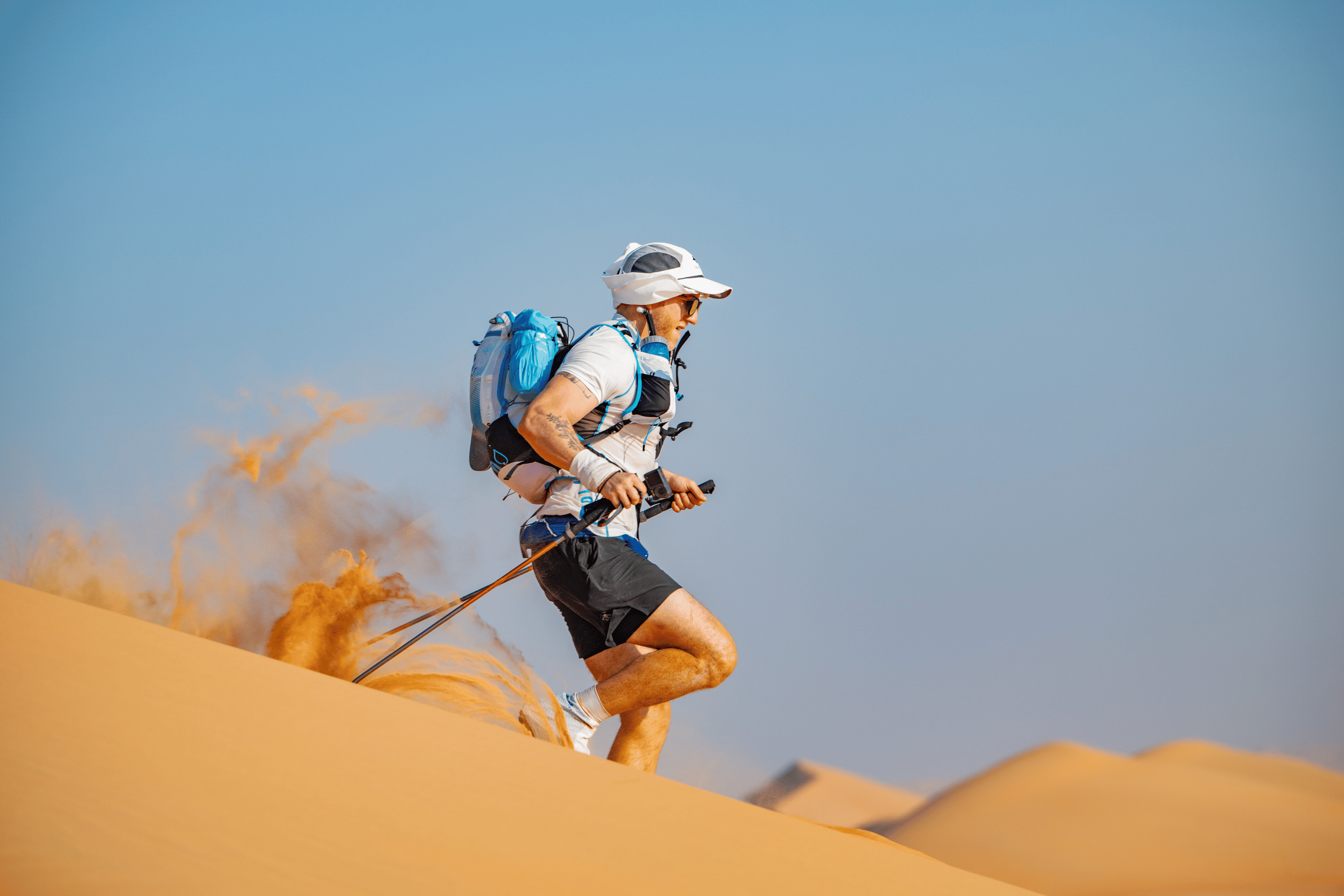 Joe Baur runs through sand at the Oman Desert Marathon