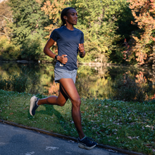 a woman runs in central park during fall
