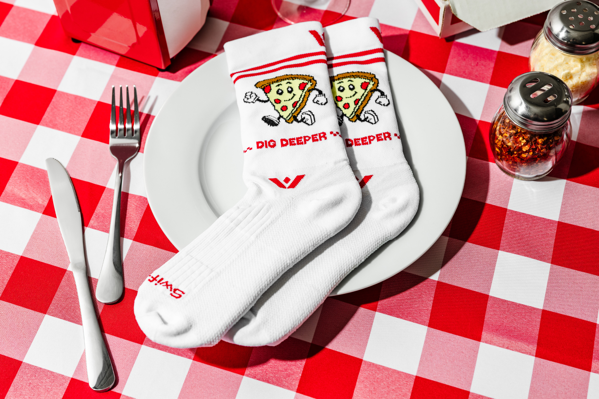 cheesy socks -- socks on a plate with pizza on them