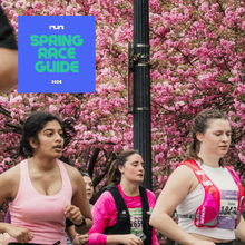 women run under a canopy of cherry blossoms