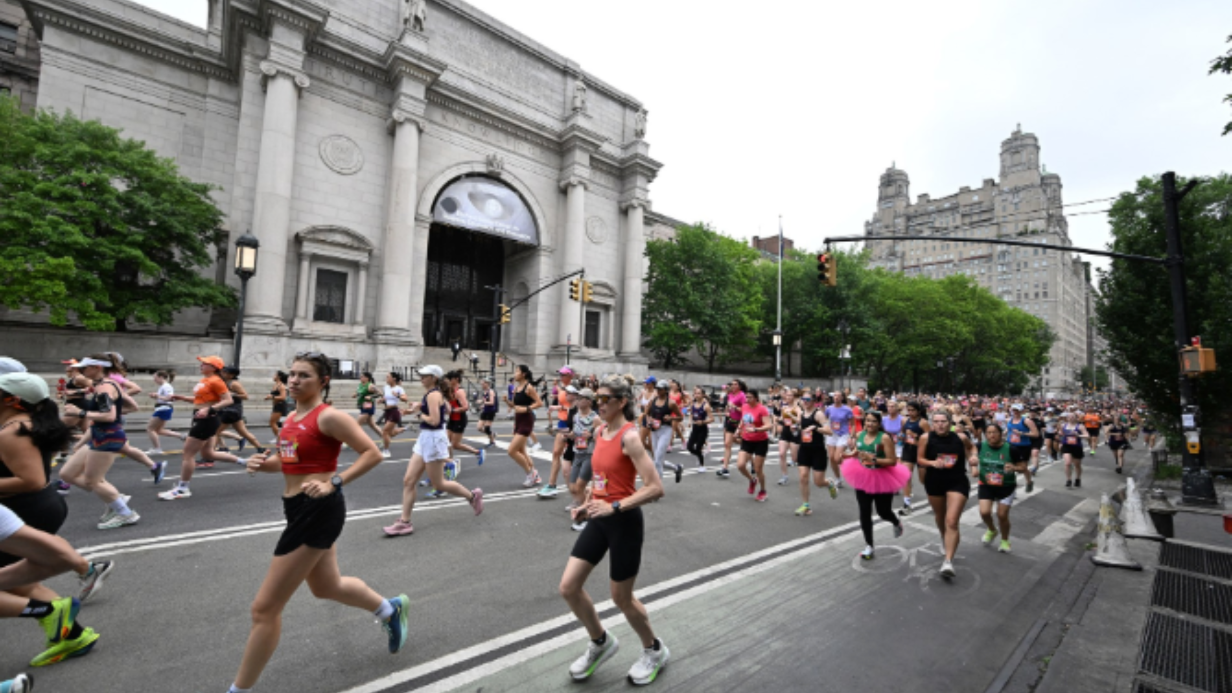 runners jogging by a museum in New York City