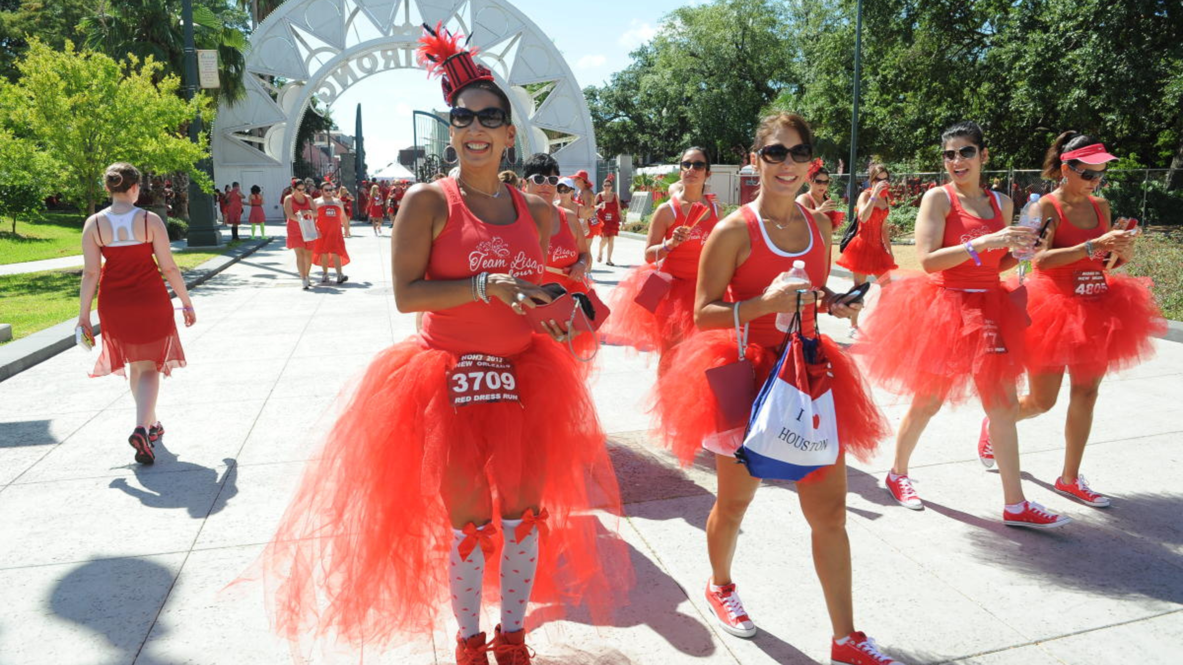 women wearing red dresses and running in new orleans