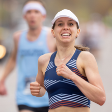 a woman running a 10K and smiling