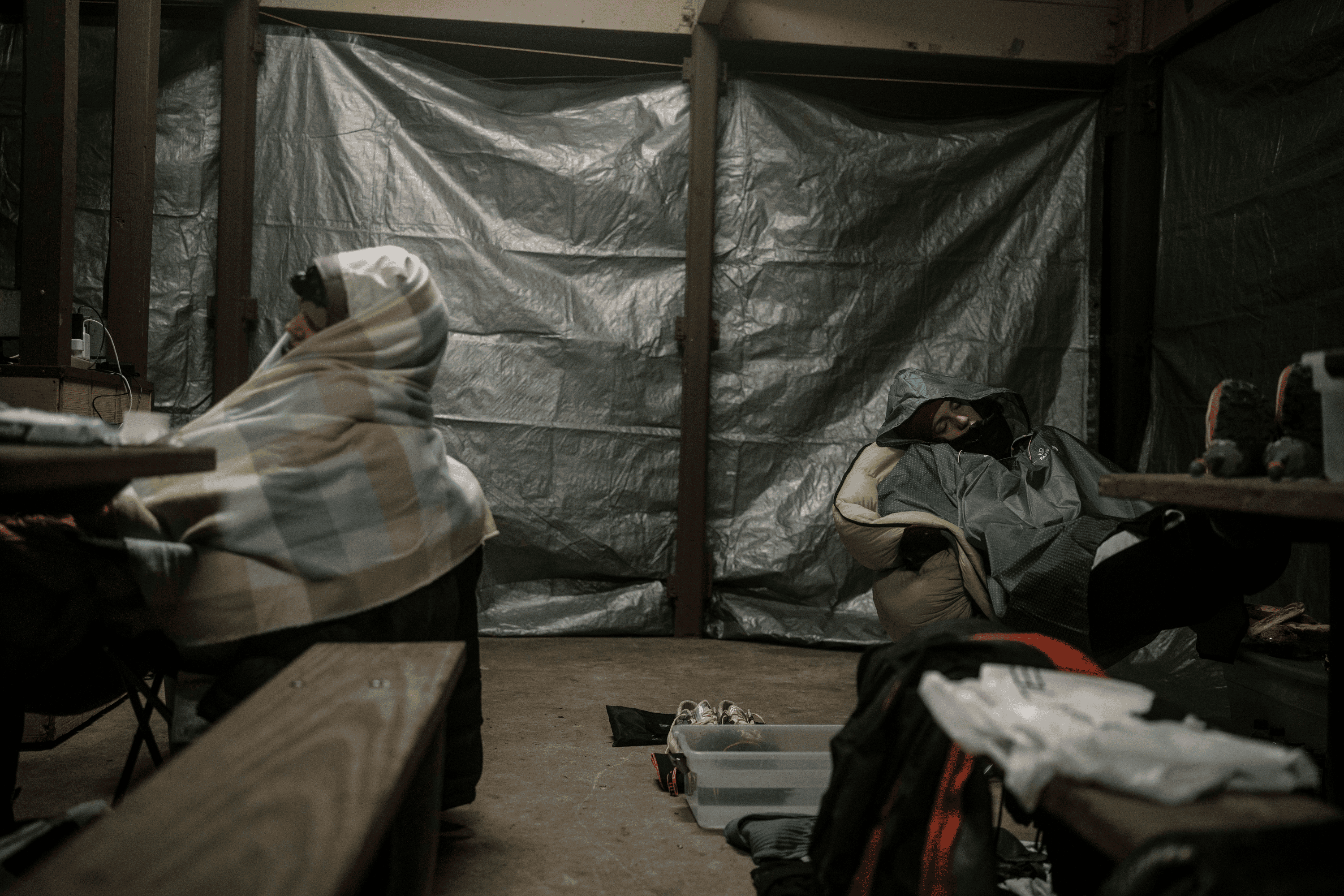 Tarps have been strung up at the shelter to keep out the impending rain. A fire burns, but the near sub-freezing temps still feel chilly for those waiting in camp.