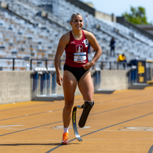 Sydney in a Stanford track uniform with her running blade and track spike