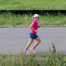 a woman in a pink top running