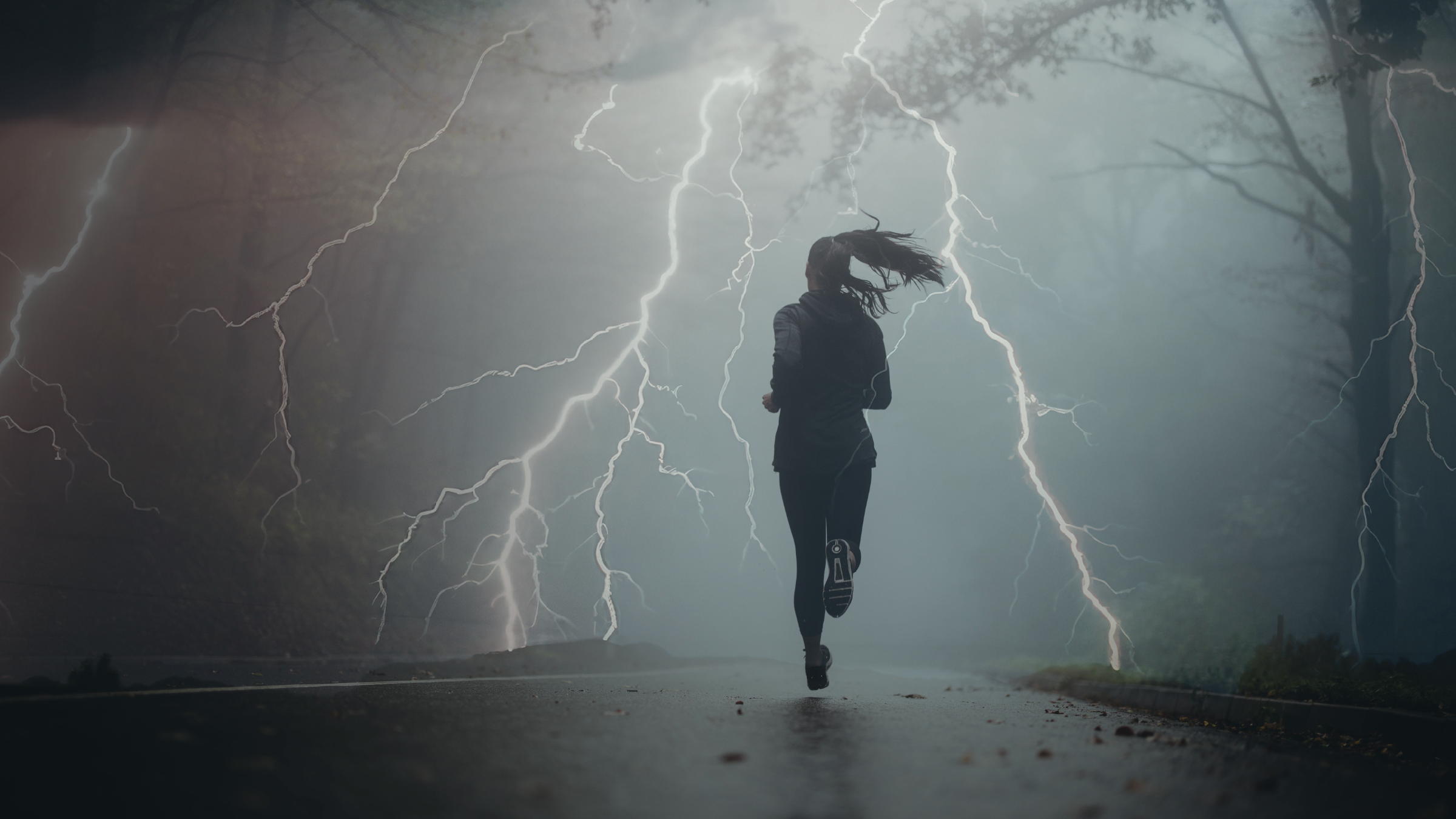 lightning strikes around a runner