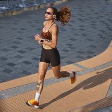 a woman in a animal-print sports bra trains for a marathon