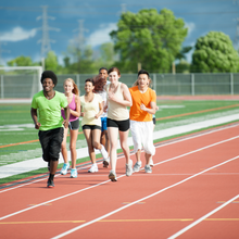 a group of happy runners doing a track workout