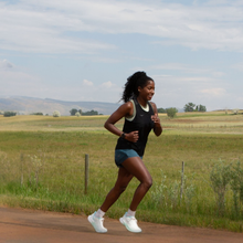 a woman runs in colorado showing off her great arm strength