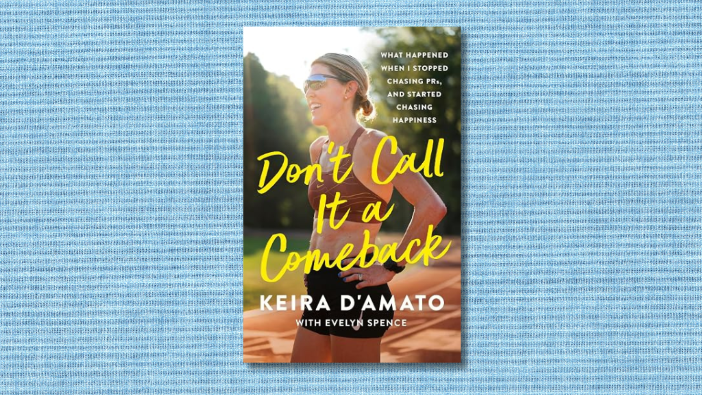 blue textured background with Keir D'Amato's book cover on it with her standing on track with hands on hips in sports bra and shorts