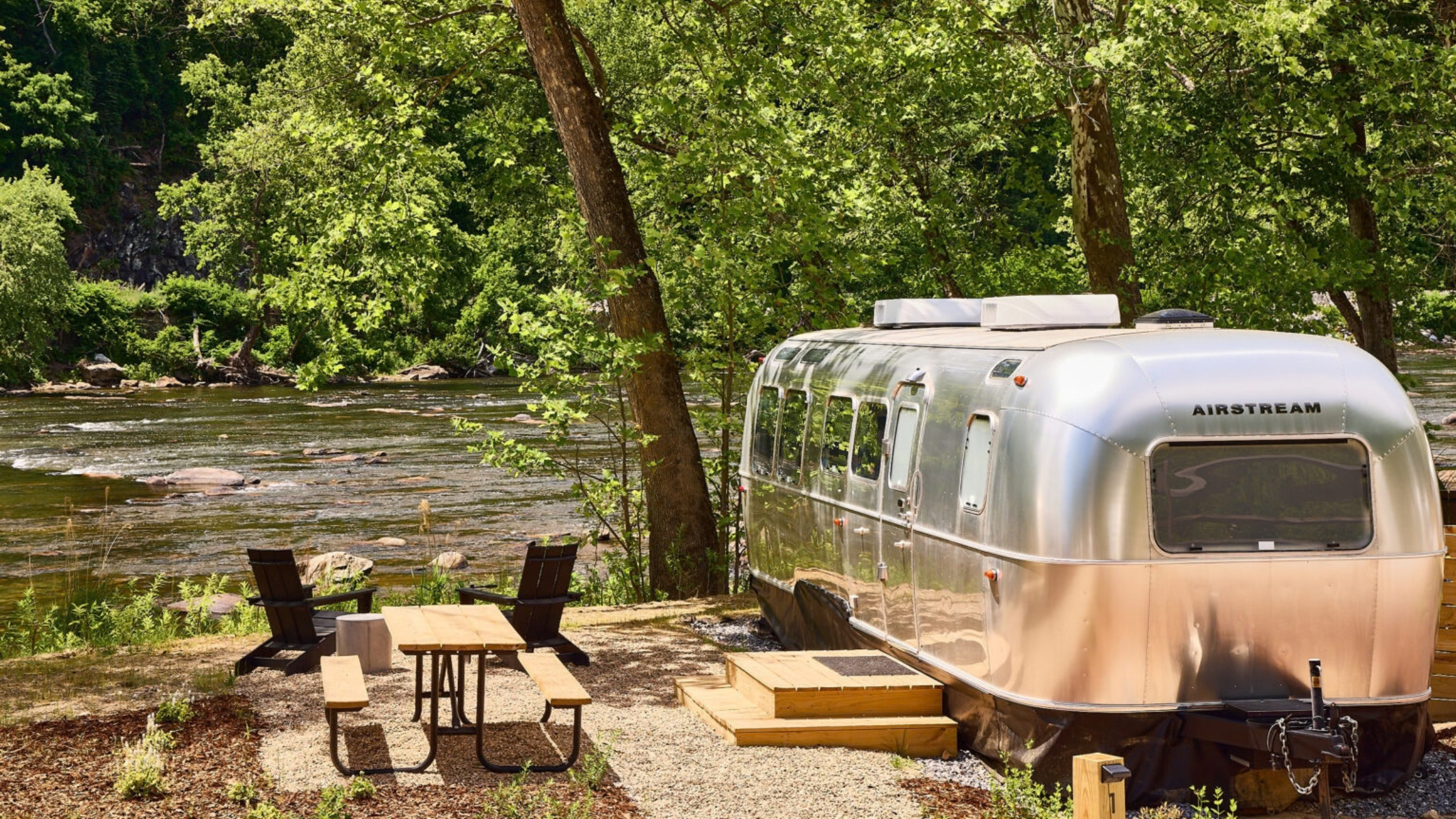 an airstrem by a river