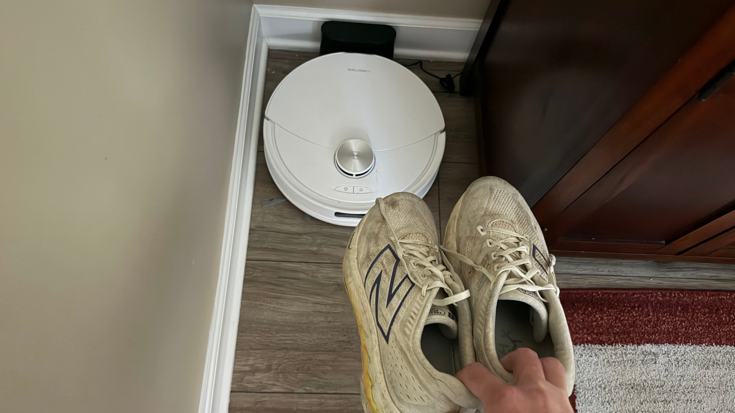 white roborock vacuum with white shoes in foreground